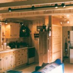 In this mountain cabin the kitchen cabinets as well as the walls and ceiling are in knotty pine. The customers wanted it to feel like living inside a tree.